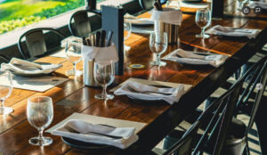 A long wooden table, ready for guests at Oscar’s Brewing Co—one of the best restaurants with private event space in Temecula.